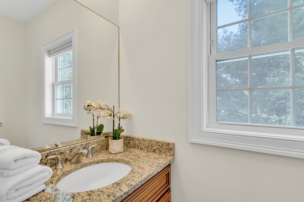 19 Bryn Mawr Road Wellesley, MA 02482 - Photo 19 of 42 a bathroom with a granite countertop sink a mirror and a window