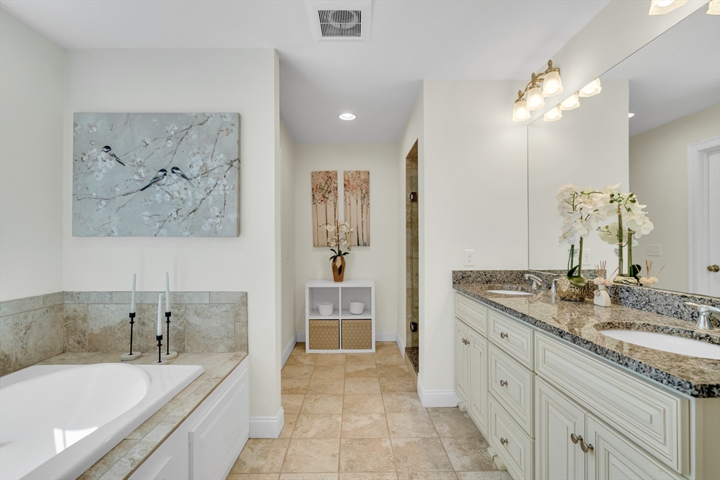 19 Bryn Mawr Road Wellesley, MA 02482 - Photo 25 of 42 a spacious bathroom with a granite countertop sink a toilet a mirror a bathtub and vanity