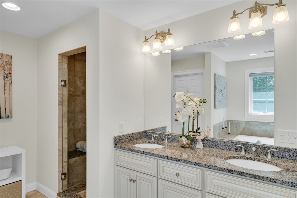 19 Bryn Mawr Road Wellesley, MA 02482 - Photo 26 of 42 a bathroom with a granite countertop double vanity sink and a mirror
