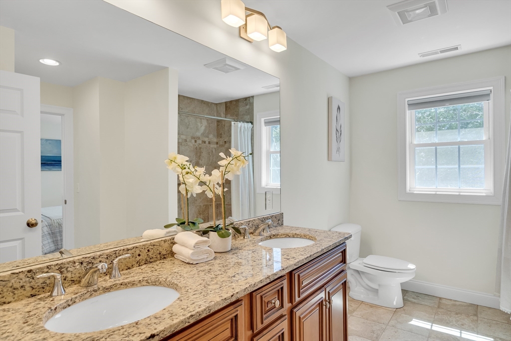 19 Bryn Mawr Road Wellesley, MA 02482 - Photo 30 of 42 a bathroom with a granite countertop toilet a sink and a mirror