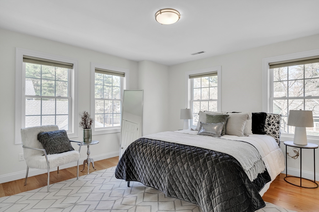 19 Bryn Mawr Road Wellesley, MA 02482 - Photo 32 of 42 a bedroom with a bed and a couch next to a window