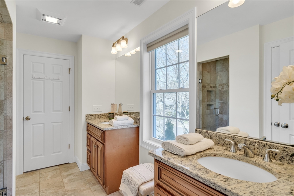19 Bryn Mawr Road Wellesley, MA 02482 - Photo 33 of 42 a bath room with a granite countertop sink a toilet a mirror and shower
