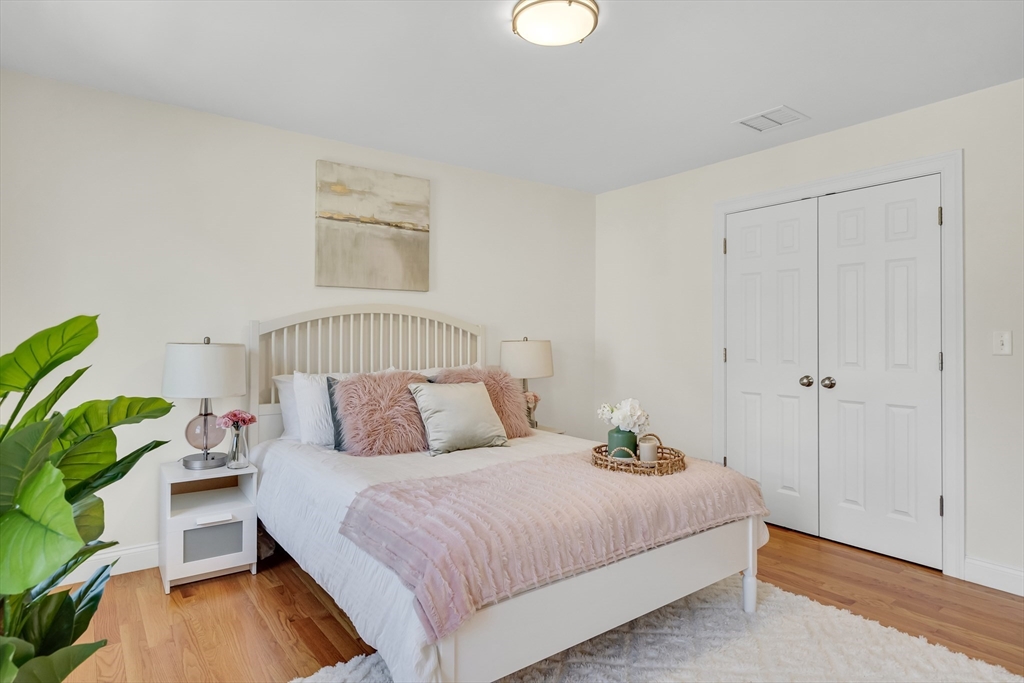 19 Bryn Mawr Road Wellesley, MA 02482 - Photo 35 of 42 a bedroom with a bed and a potted plant