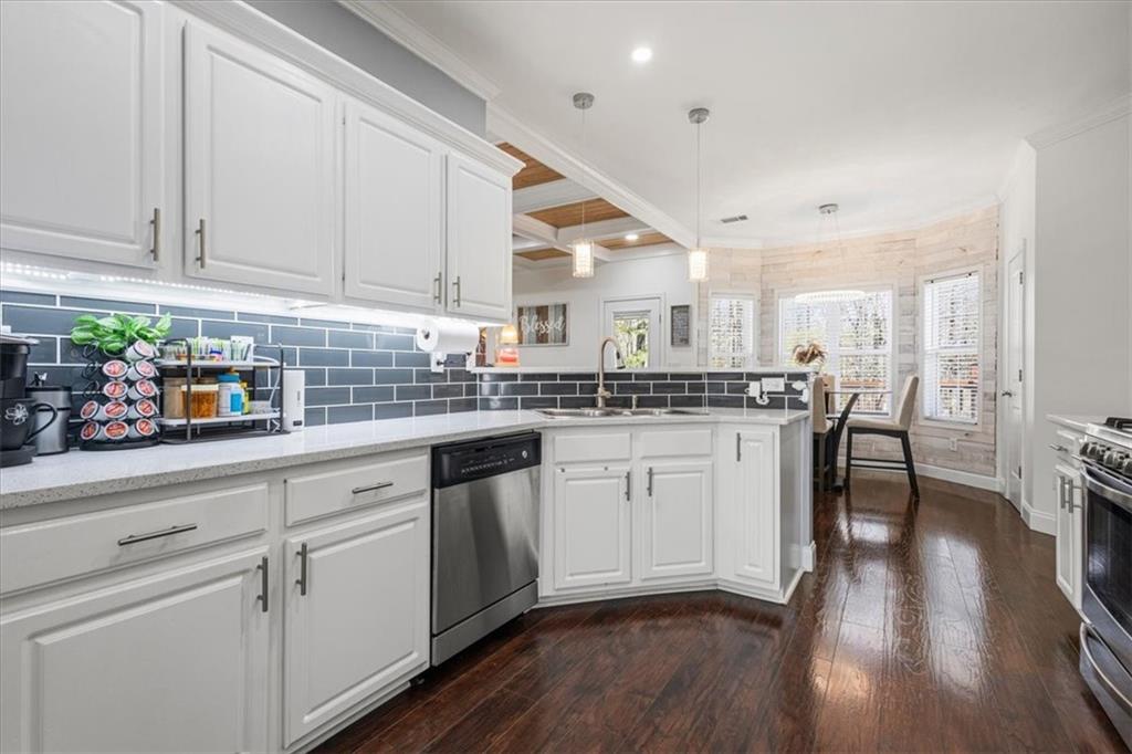 1380 Commonwealth Lane Grayson, GA 30017 - Photo 15 of 46 a kitchen with granite countertop white cabinets and white appliances