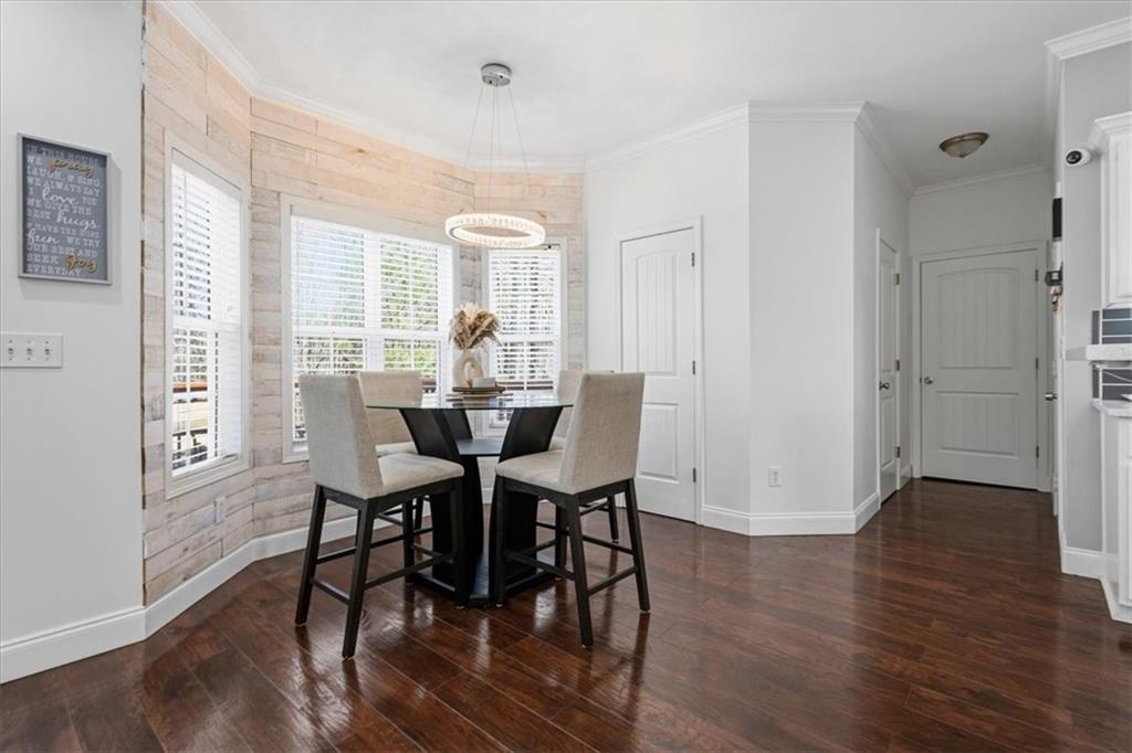 1380 Commonwealth Lane Grayson, GA 30017 - Photo 17 of 46 a view of a dining room with furniture and wooden floor