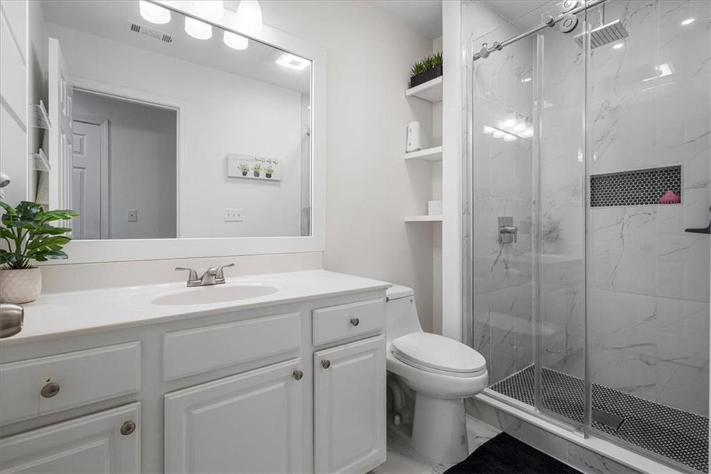 1380 Commonwealth Lane Grayson, GA 30017 - Photo 26 of 46 a bathroom with a toilet sink and shower