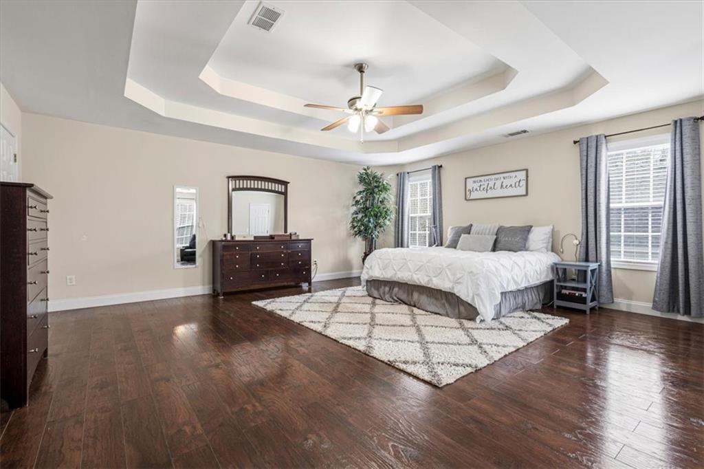 1380 Commonwealth Lane Grayson, GA 30017 - Photo 27 of 46 a bedroom with a bed and a chandelier