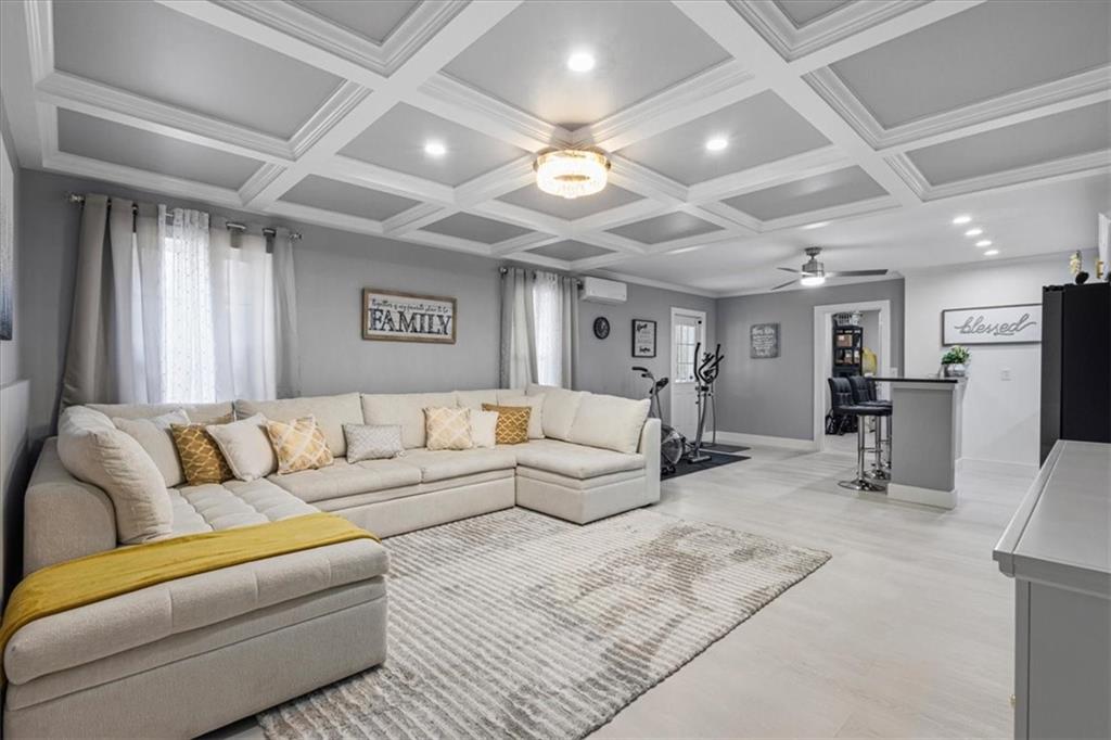 1380 Commonwealth Lane Grayson, GA 30017 - Photo 33 of 46 a living room with furniture kitchen view and a chandelier