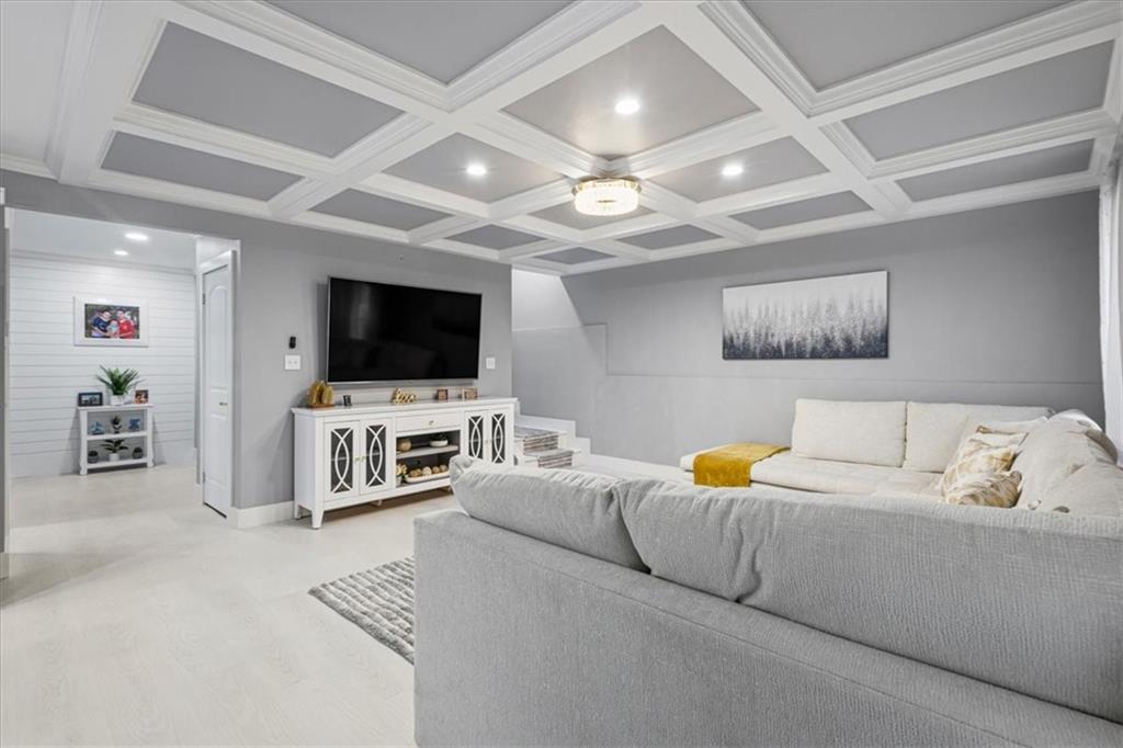 1380 Commonwealth Lane Grayson, GA 30017 - Photo 34 of 46 a living room with furniture and a flat screen tv