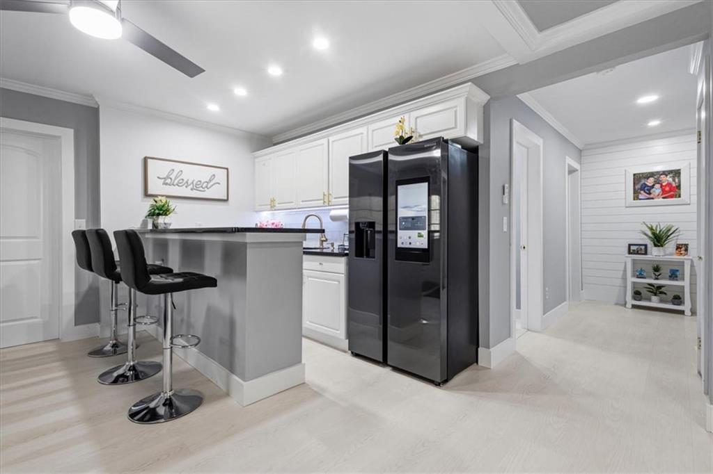1380 Commonwealth Lane Grayson, GA 30017 - Photo 38 of 46 a kitchen with stainless steel appliances kitchen island granite countertop a refrigerator and a stove top oven