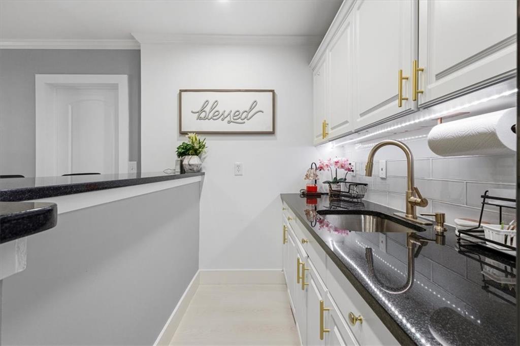 1380 Commonwealth Lane Grayson, GA 30017 - Photo 39 of 46 a kitchen with granite countertop a sink a counter top space and cabinets