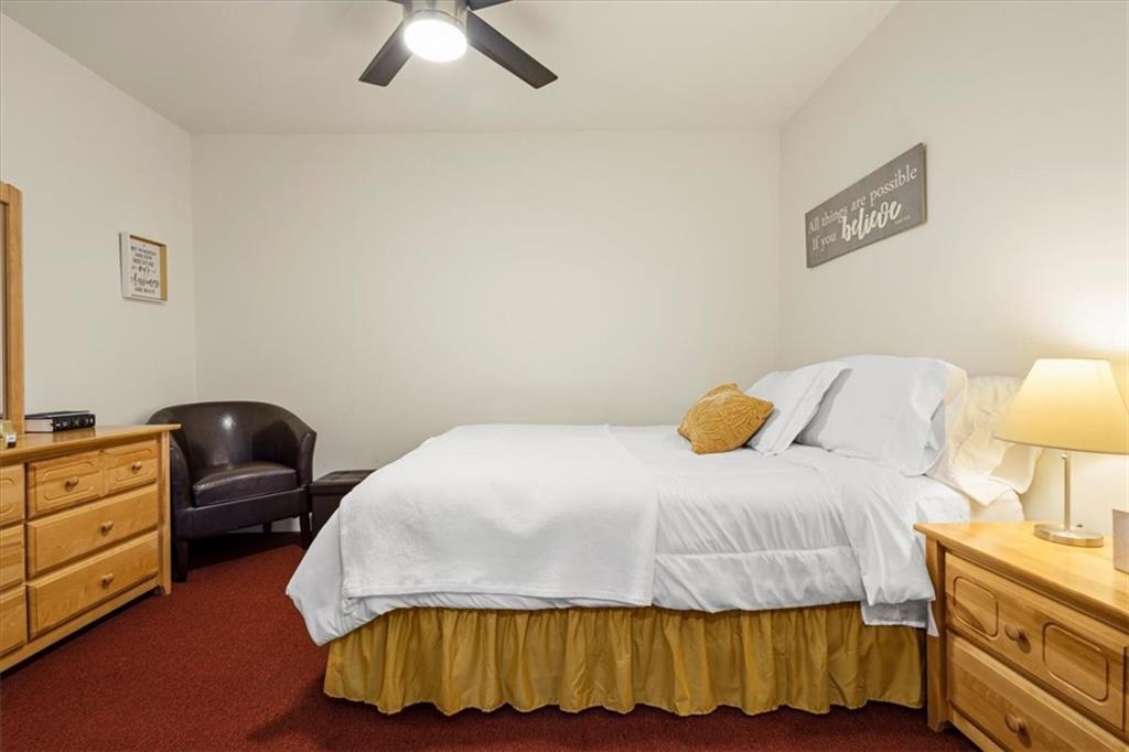 1380 Commonwealth Lane Grayson, GA 30017 - Photo 40 of 46 a bedroom with a bed and a lamp on dresser