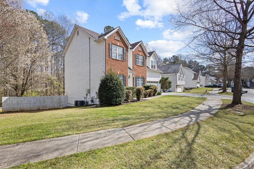 1380 Commonwealth Lane Grayson, GA 30017 - Photo 4 of 46 a view of a white house with a big yard and large trees