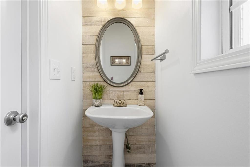 1380 Commonwealth Lane Grayson, GA 30017 - Photo 42 of 46 a bathroom with a sink and a mirror