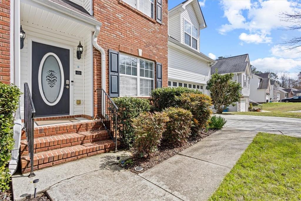 1380 Commonwealth Lane Grayson, GA 30017 - Photo 5 of 46 a view of a house with a small yard and a large tree