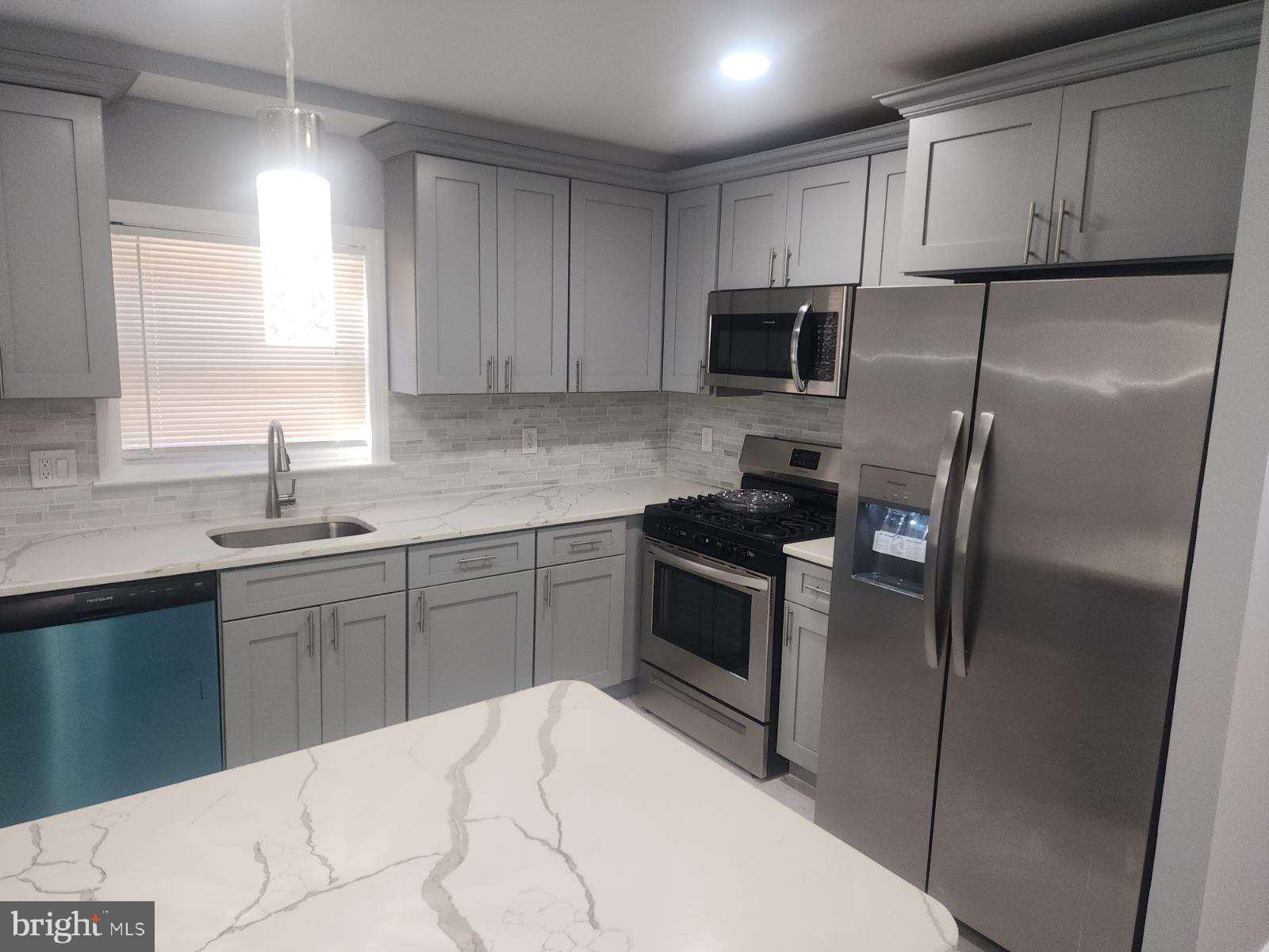 2218 Strahle Street Philadelphia, PA 19152 - Photo 11 of 22 a kitchen with a refrigerator sink and microwave