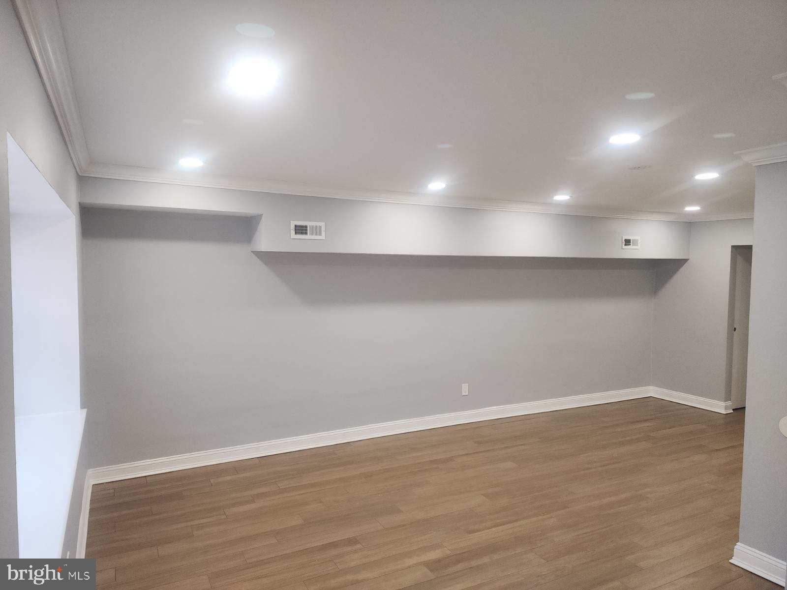 2218 Strahle Street Philadelphia, PA 19152 - Photo 12 of 22 an empty room with wooden floor and windows