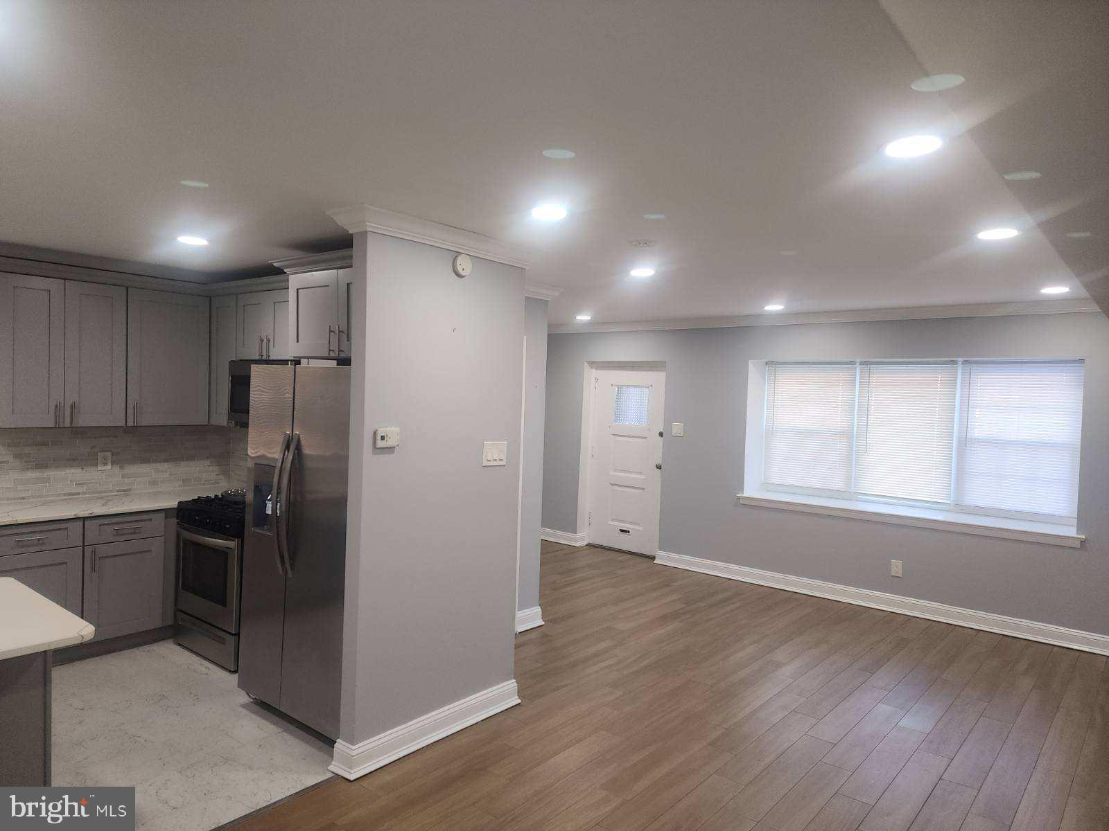 2218 Strahle Street Philadelphia, PA 19152 - Photo 14 of 22 an empty room with stainless steel appliances kitchen island granite countertop a refrigerator and cabinets