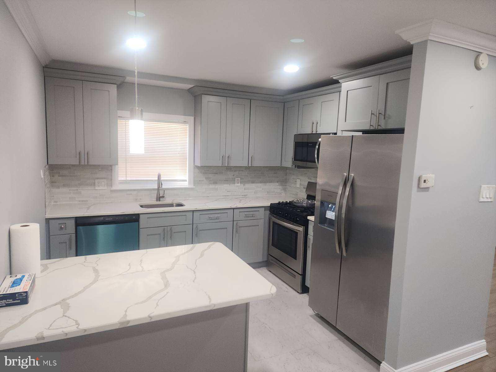 2218 Strahle Street Philadelphia, PA 19152 - Photo 15 of 22 a kitchen with stainless steel appliances granite countertop a refrigerator sink and stove