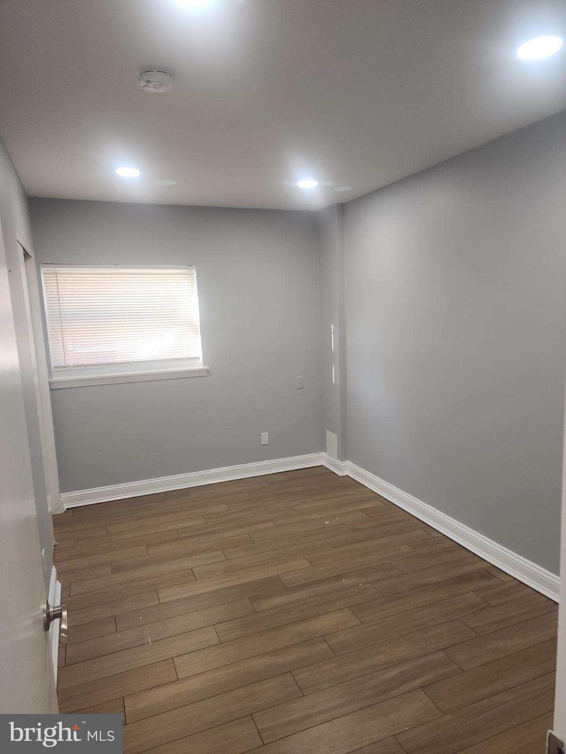 2218 Strahle Street Philadelphia, PA 19152 - Photo 17 of 22 an empty room with wooden floor and windows
