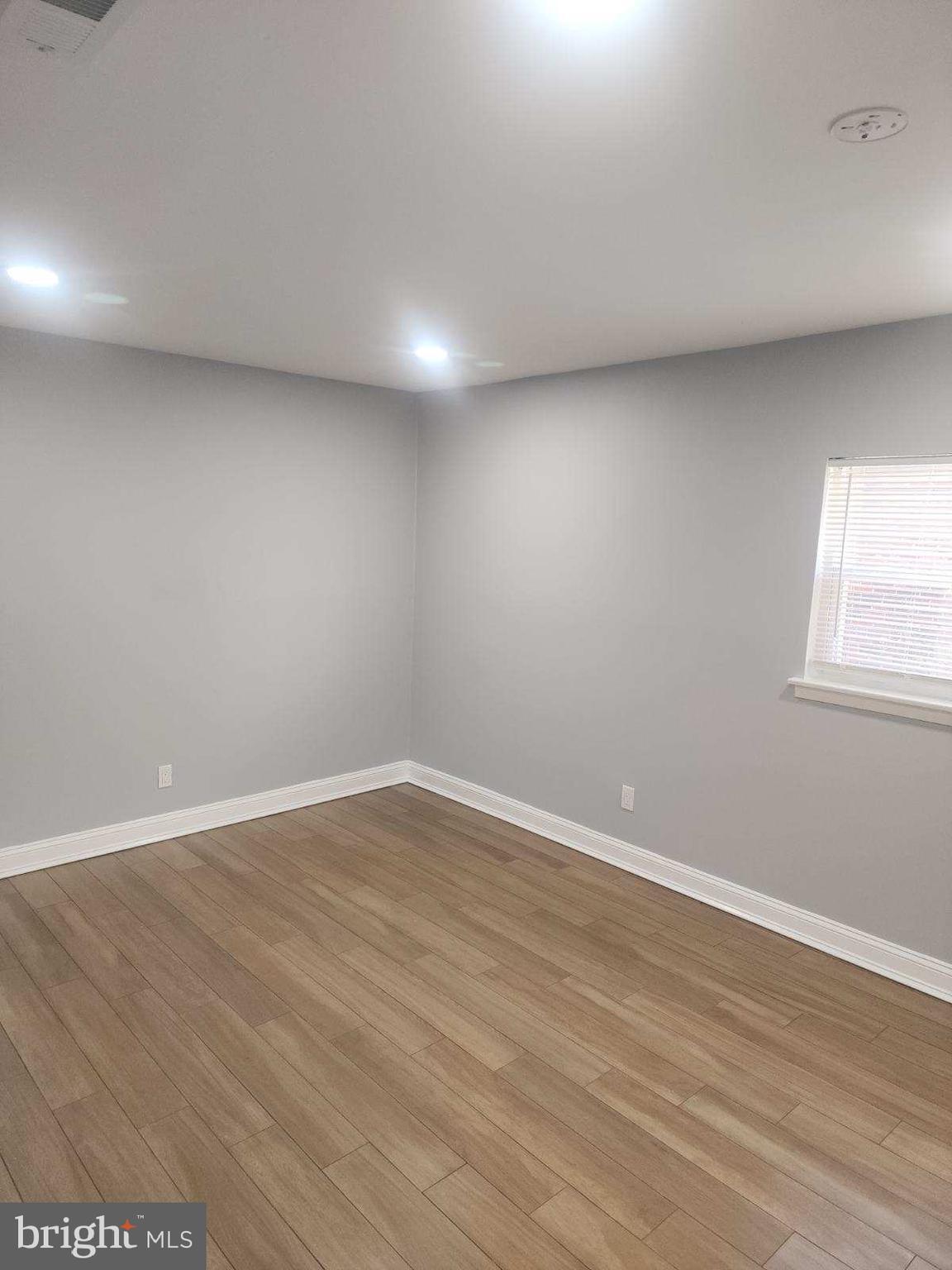 2218 Strahle Street Philadelphia, PA 19152 - Photo 20 of 22 an empty room with wooden floor and windows