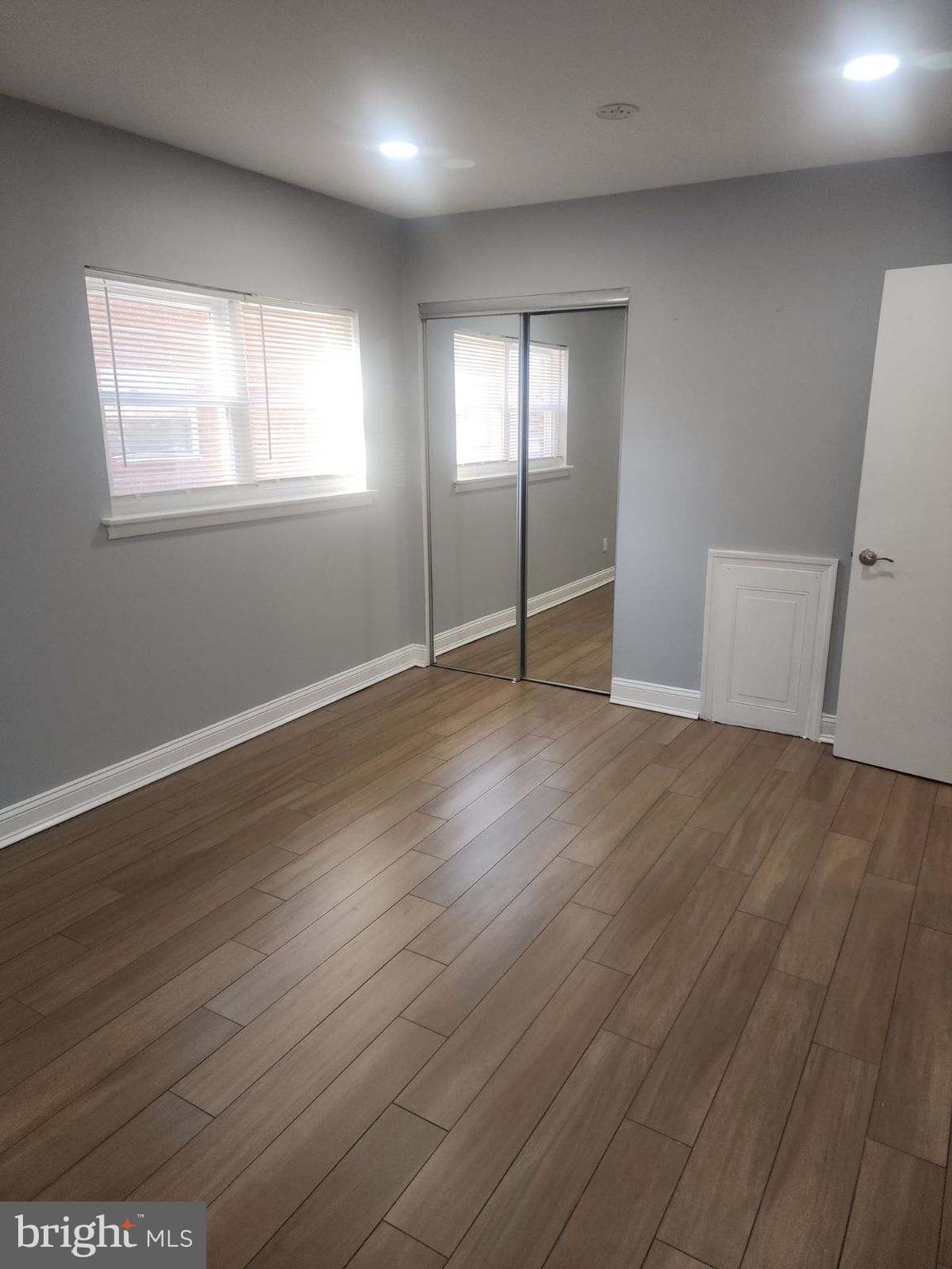 2218 Strahle Street Philadelphia, PA 19152 - Photo 5 of 22 an empty room with wooden floor and windows