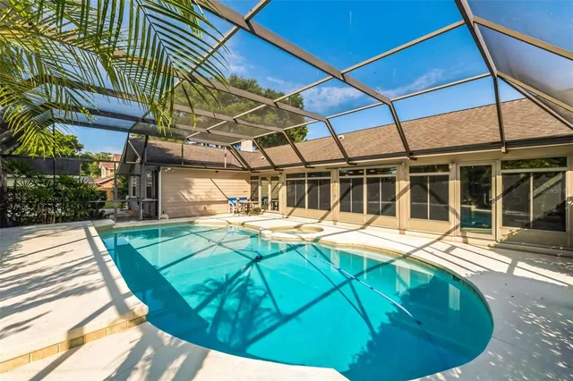 a view of a house with backyard and sitting area