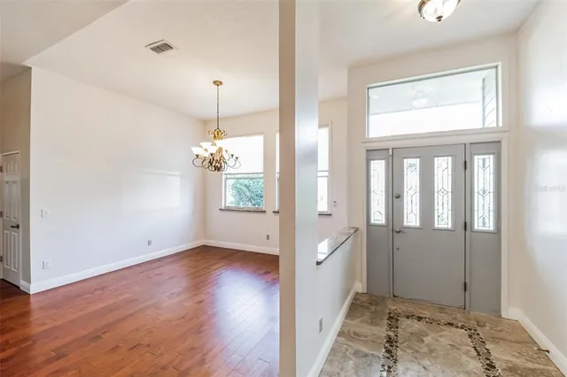 a view of a room with wooden floor and a window