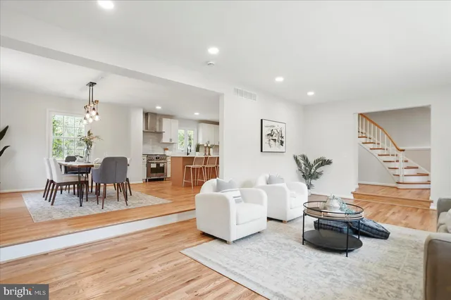 a white kitchen with a stove top oven sink and cabinets