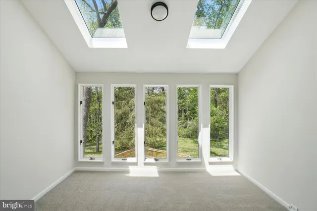 a spacious bedroom with a large bed and a window