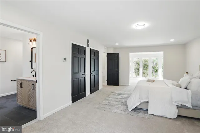 a spacious bathroom with a shower sink and mirror