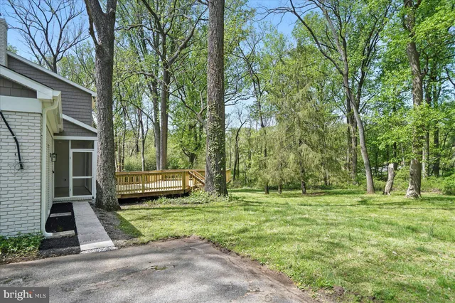 a view of a backyard with a garden and entertaining space