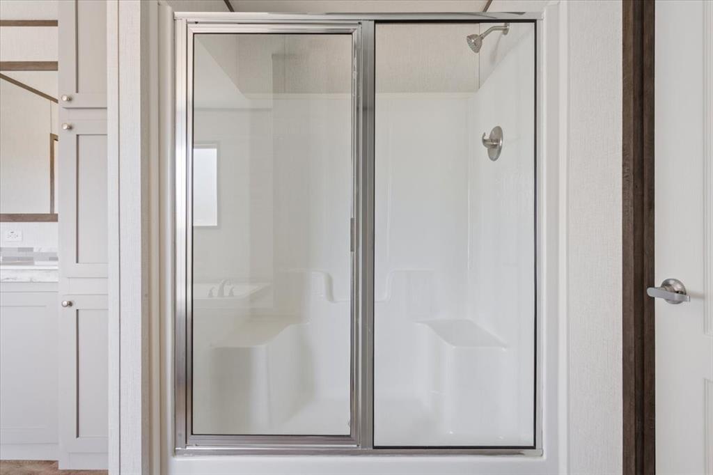 201 North Carpenter Street Mart, TX 76664 - Photo 16 of 30 a bathroom with a glass shower door