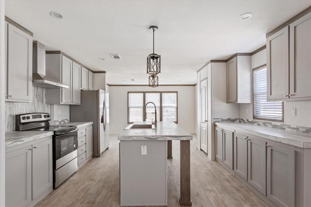 201 North Carpenter Street Mart, TX 76664 - Photo 2 of 30 a kitchen with stainless steel appliances granite countertop a sink stove and refrigerator