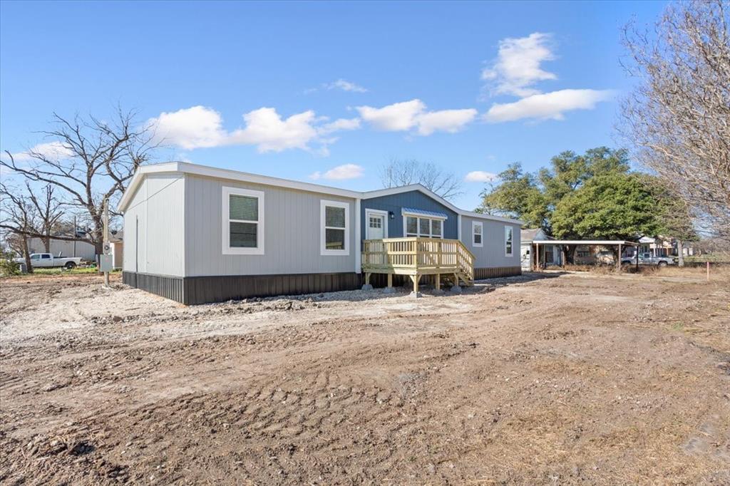201 North Carpenter Street Mart, TX 76664 - Photo 26 of 30 a front view of a house with a yard and garage