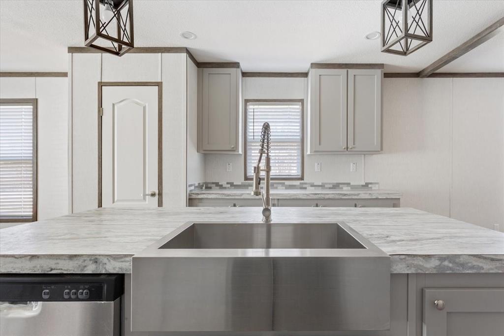 201 North Carpenter Street Mart, TX 76664 - Photo 4 of 30 a kitchen with a sink a stove and cabinets
