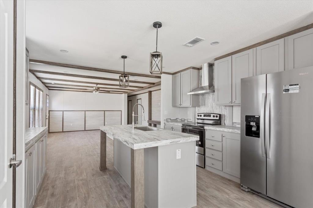 201 North Carpenter Street Mart, TX 76664 - Photo 6 of 30 a kitchen with kitchen island a counter top space a sink and refrigerator