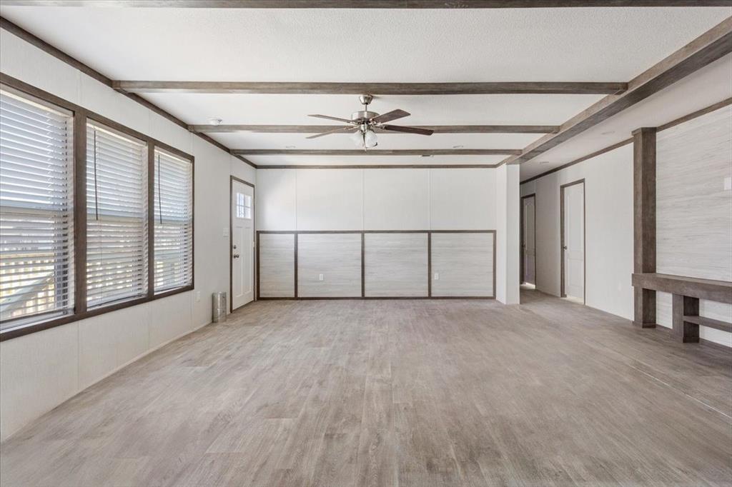201 North Carpenter Street Mart, TX 76664 - Photo 7 of 30 a view of a livingroom with a ceiling fan and window