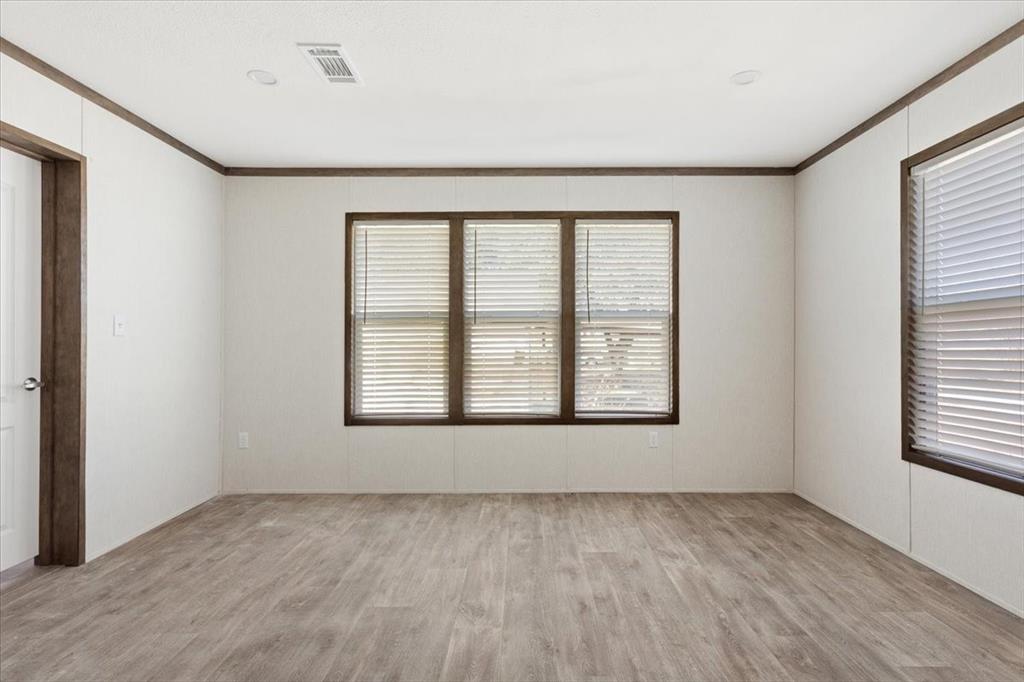201 North Carpenter Street Mart, TX 76664 - Photo 10 of 30 a big room with wooden floor and windows