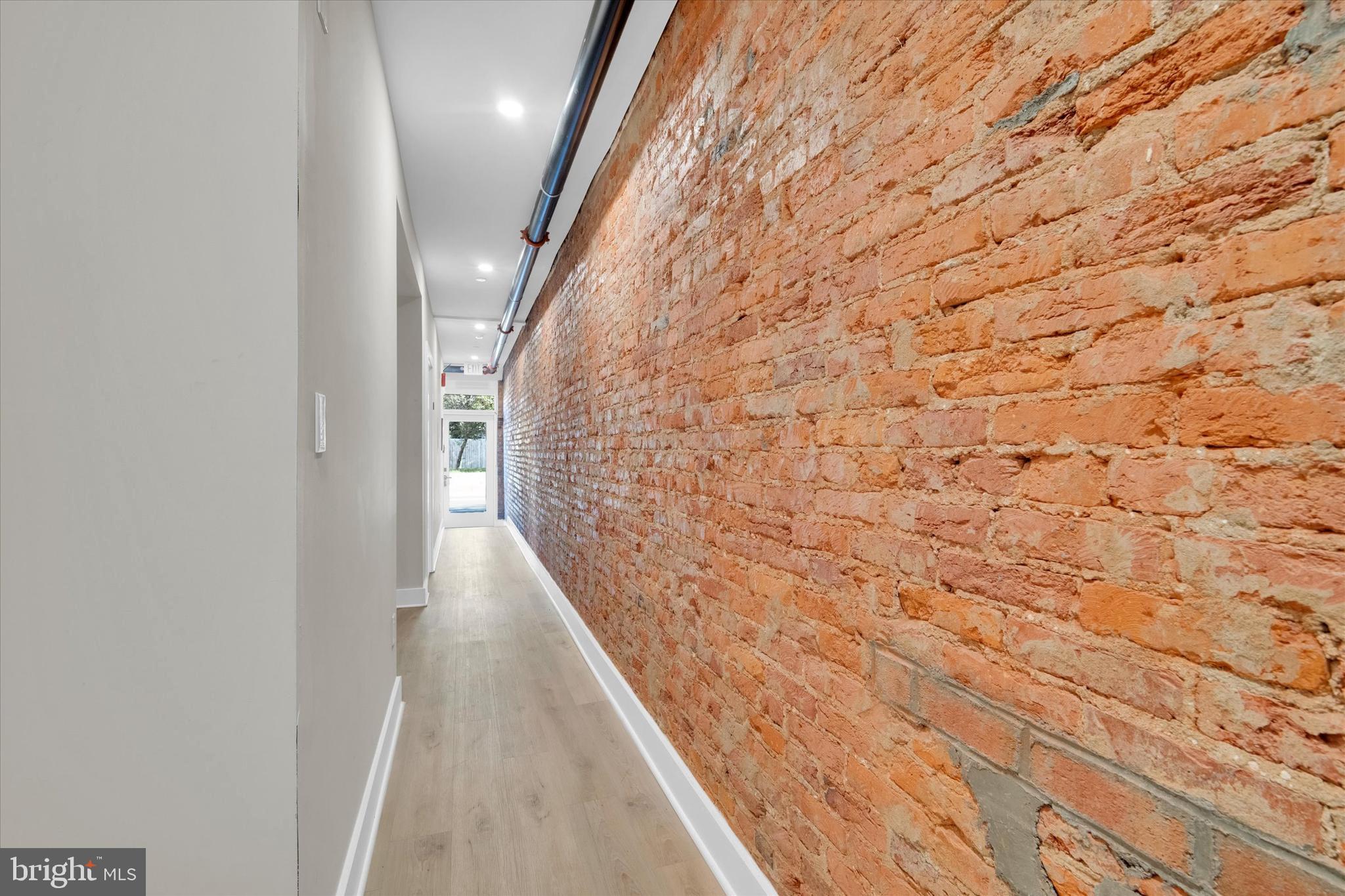 1915 Benning Road Northeast, Unit 3 Washington, DC 20002 - Photo 15 of 16 a hallway with wooden floor