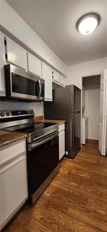 232 Afton Square, Unit 108 Altamonte Springs, FL 32714 - Photo 13 of 26 a kitchen with stainless steel appliances a stove a microwave and a hard wood floor