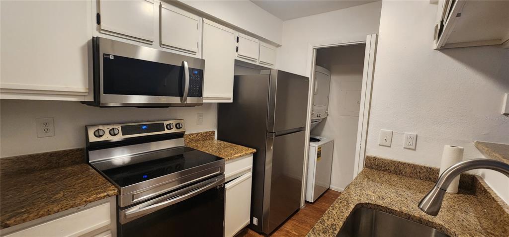 232 Afton Square, Unit 108 Altamonte Springs, FL 32714 - Photo 17 of 26 a kitchen with stainless steel appliances a refrigerator stove and microwave