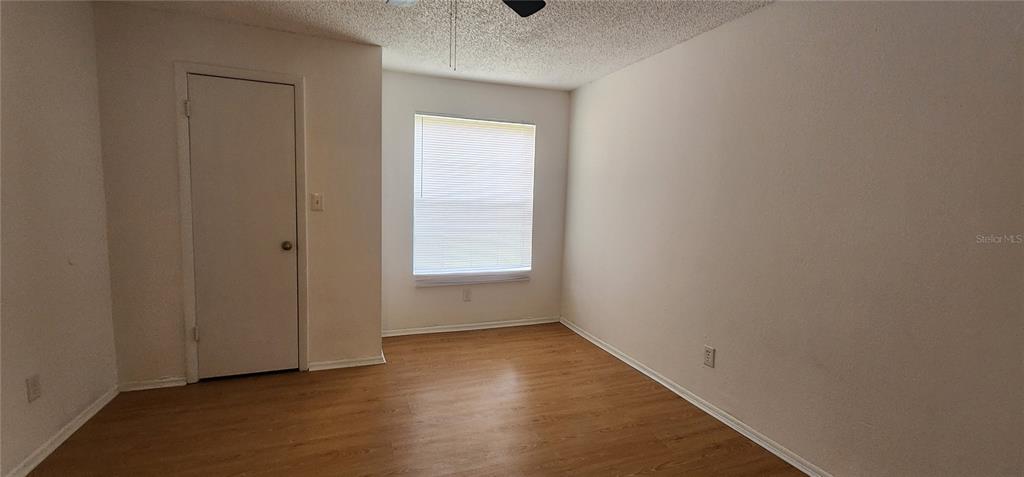 232 Afton Square, Unit 108 Altamonte Springs, FL 32714 - Photo 20 of 26 a view of an empty room with wooden floor and a window