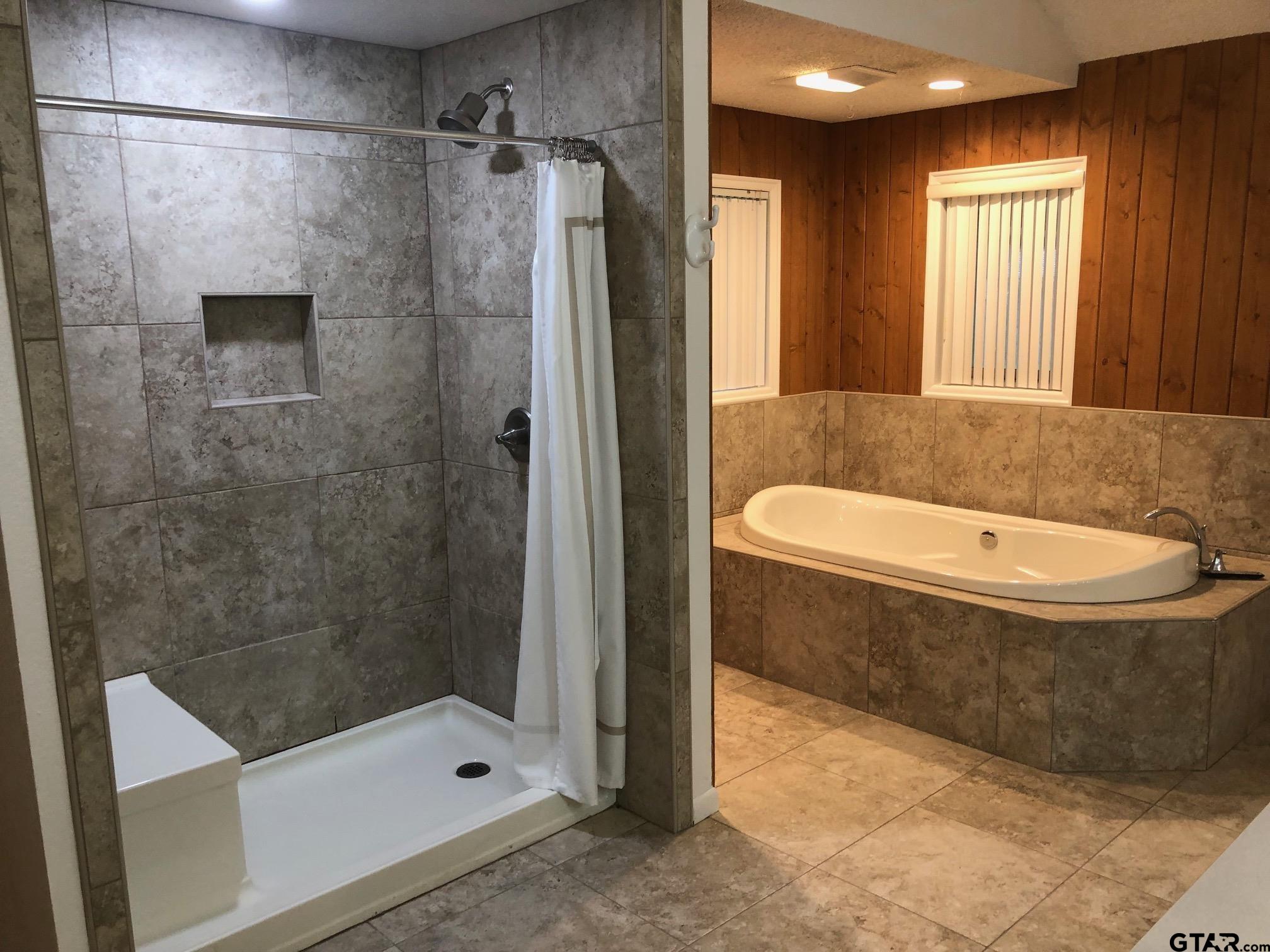 13745 Meadow Lane Flint, TX 75762 - Photo 25 of 38 a bathroom with a tub and a shower