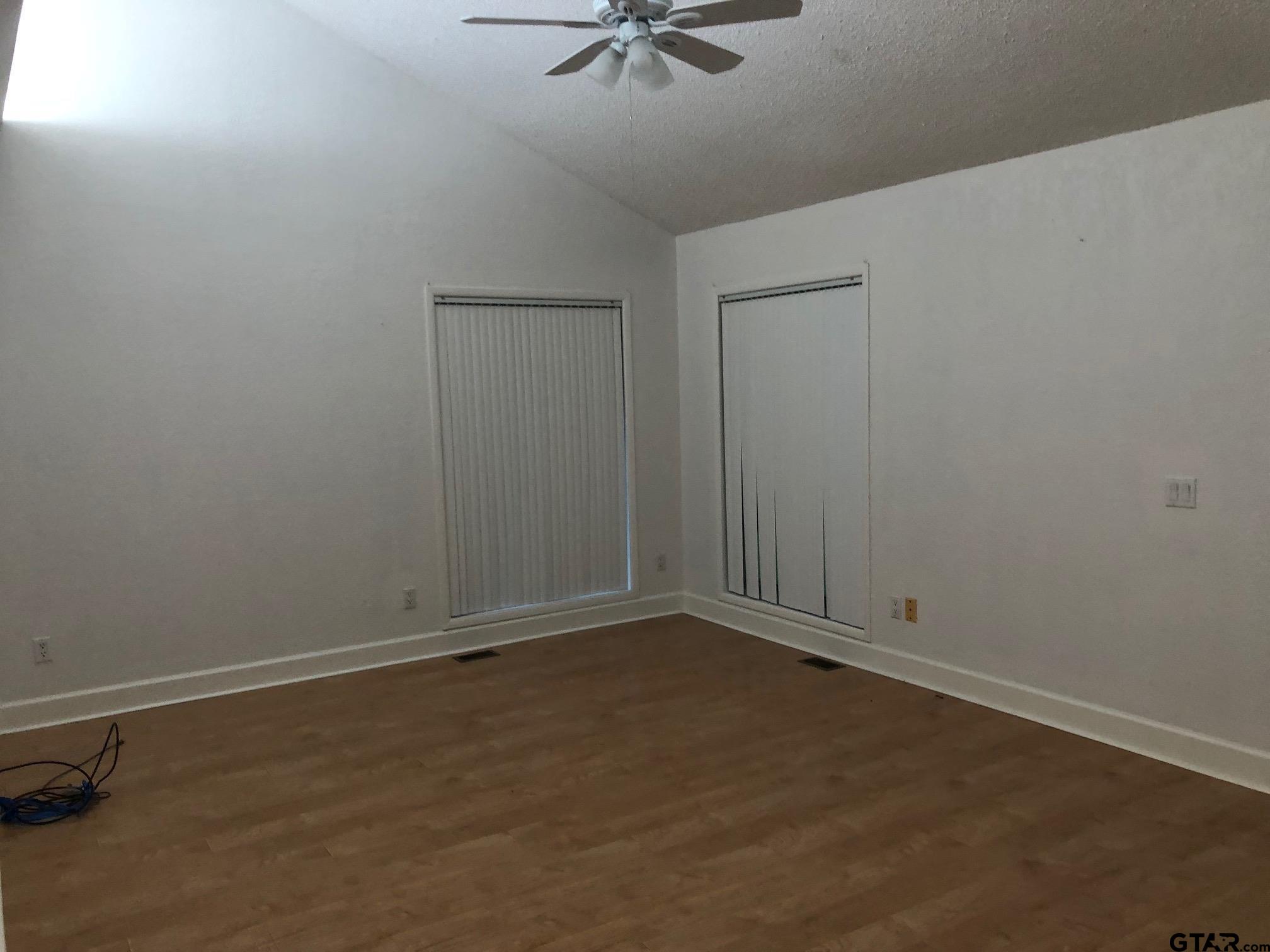 13745 Meadow Lane Flint, TX 75762 - Photo 29 of 38 an empty room with a ceiling fan and carpet