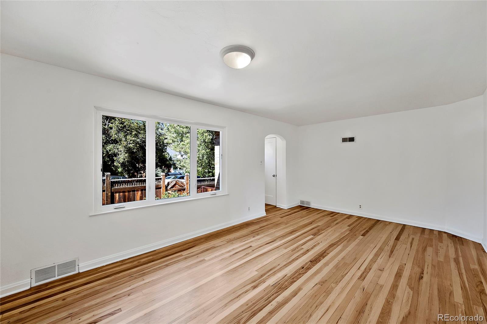 874 9th Street Boulder, CO 80302 - Photo 5 of 23 a view of an empty room with a window and wooden floor