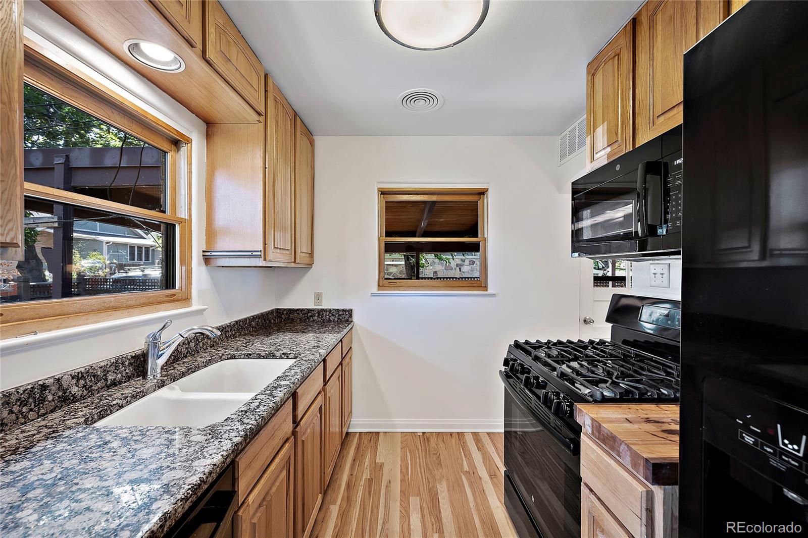 874 9th Street Boulder, CO 80302 - Photo 9 of 23 a kitchen with granite countertop stainless steel appliances and wooden cabinets