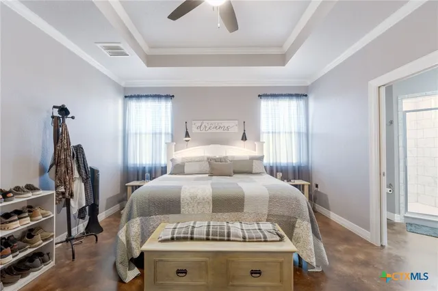 a bed sitting in a bedroom next to a window