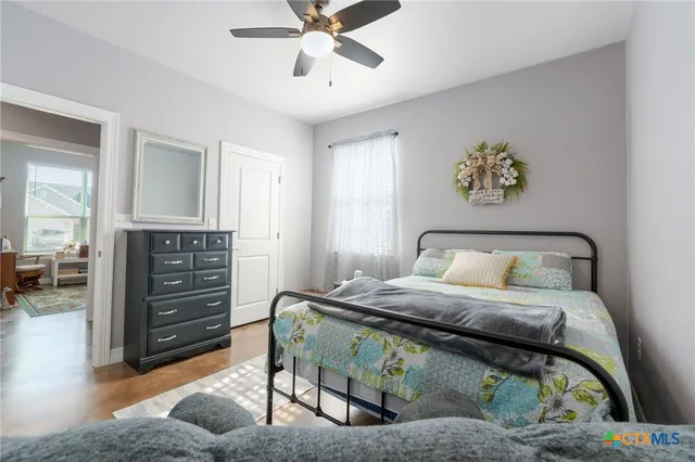 a bedroom with a bed and a chandelier