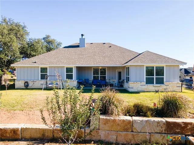 a view of a house with swimming pool and sitting area